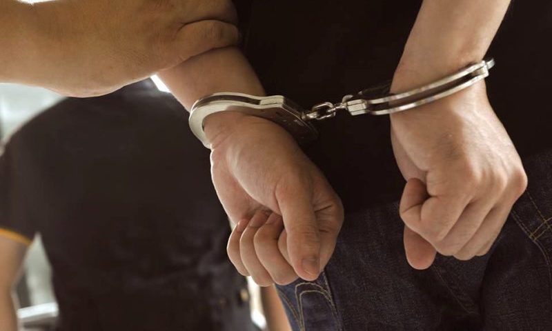 a close-up of hands in handcuffs