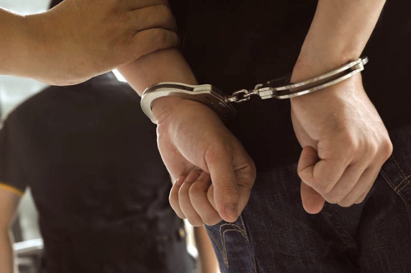 a close-up of hands in handcuffs