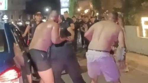 a group of men fighting in a crowd